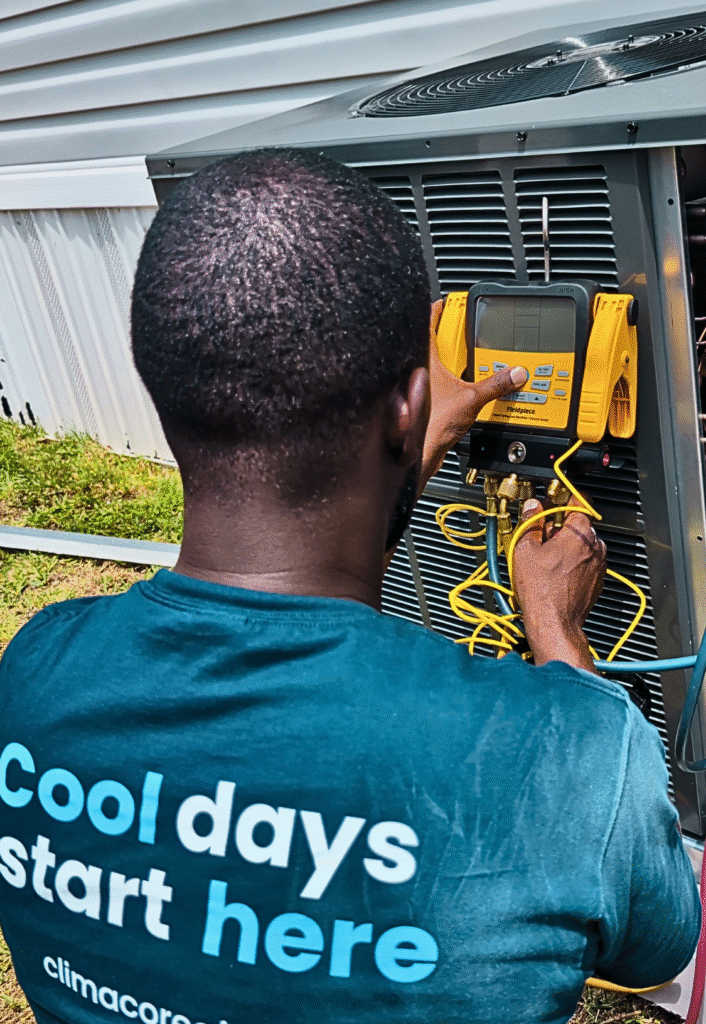 Technician performing air conditioner maintenance near Florida home